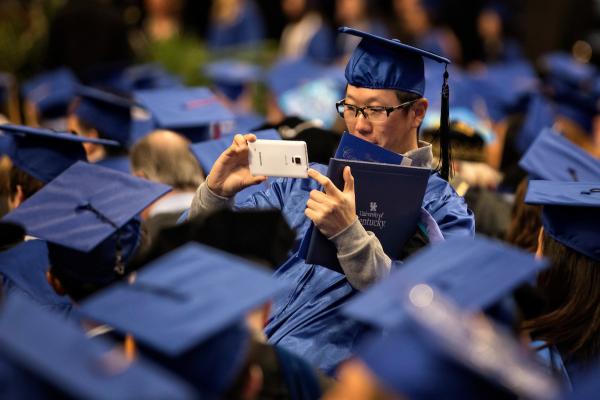 Student taking photo at graduation