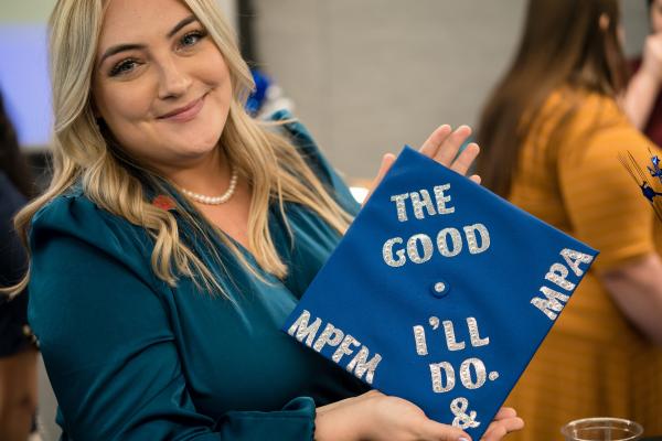Graduating student holding cap