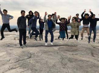 2019 IPPMI group jumping in the air on a mountain