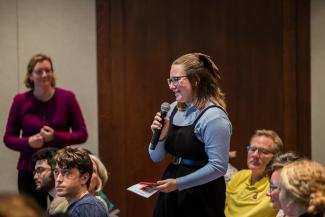 Student audience member asks a question at The Injustice of Place forum