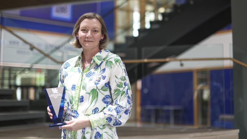 Dr. Cory Curl photographed holding her award at the 2025 Outstanding Teaching Award ceremony.