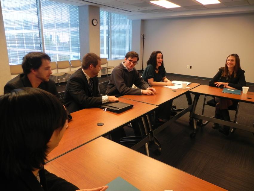 Group of students talking around a table