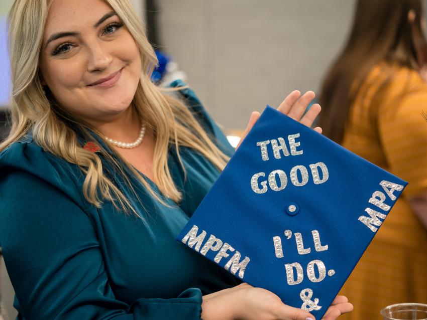 Graduating student holding cap