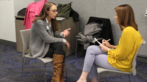Two students discussing their capstone projects