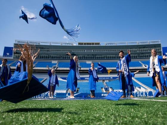 Graduates throwing caps into the air