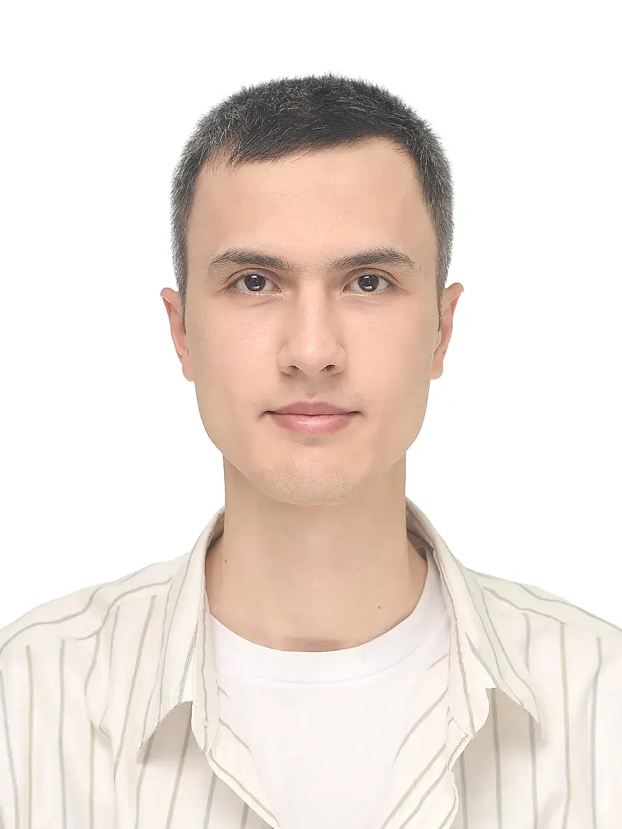 Portait photo of Dilshod Nurmetov - he is facing the camera head on and wearing a white t-shirt and button up shirt, background is white.